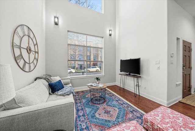 709 E 1st St, Fort Worth, TX 76102 - living area featuring wood finished floors, a high ceiling, and baseboards