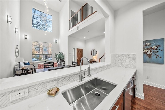 709 E 1st St, Fort Worth, TX 76102 - kitchen featuring a sink, a high ceiling, dark wood finished floors, baseboards, and light stone counters