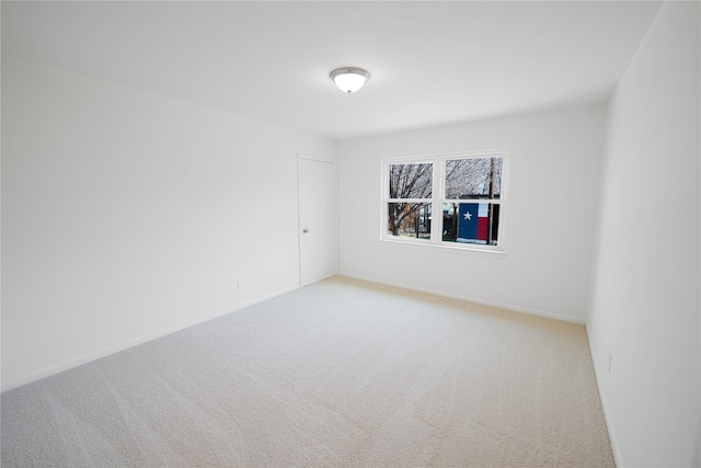 empty room with light carpet and baseboards