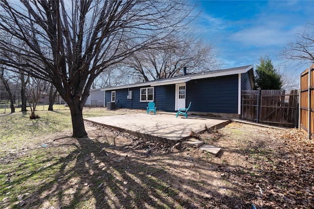 back of property featuring central AC, a patio area, and fence