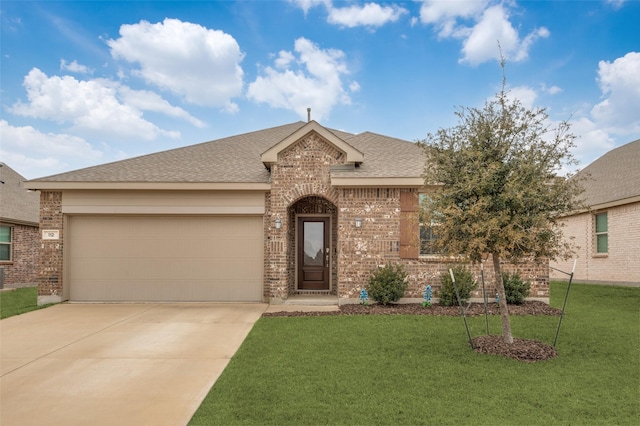 112 Mills Dr, Anna, TX 75409 - view of front facade with concrete driveway, an attached garage, a front yard, brick siding, and roof with shingles