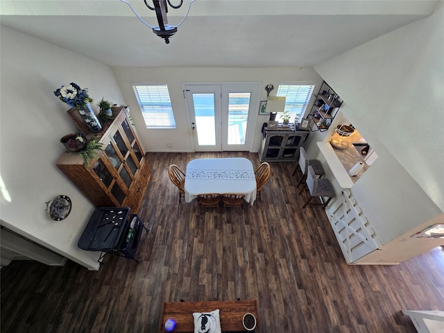 living area featuring baseboards and dark wood-style flooring