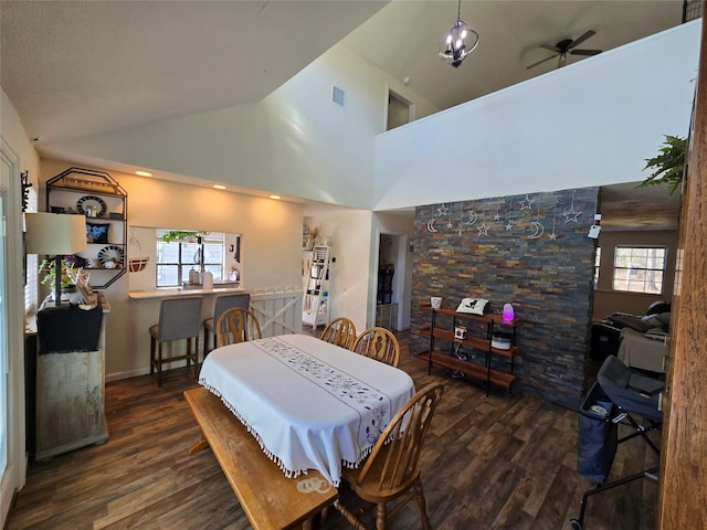 dining room featuring dark wood-style floors, ceiling fan, visible vents, and high vaulted ceiling