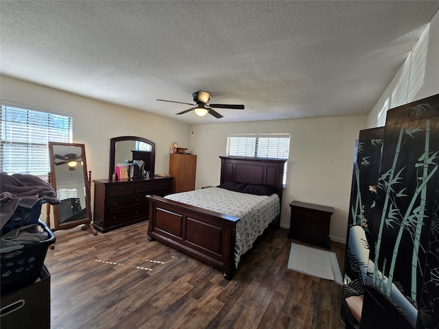 bedroom featuring dark wood-style floors, a textured ceiling, and a ceiling fan