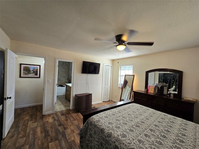 bedroom featuring dark wood-style flooring, a textured ceiling, and baseboards