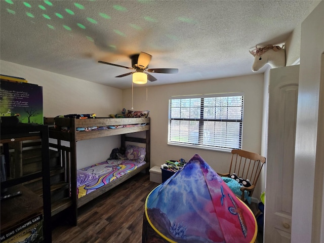 bedroom featuring ceiling fan, a textured ceiling, and dark wood-style flooring