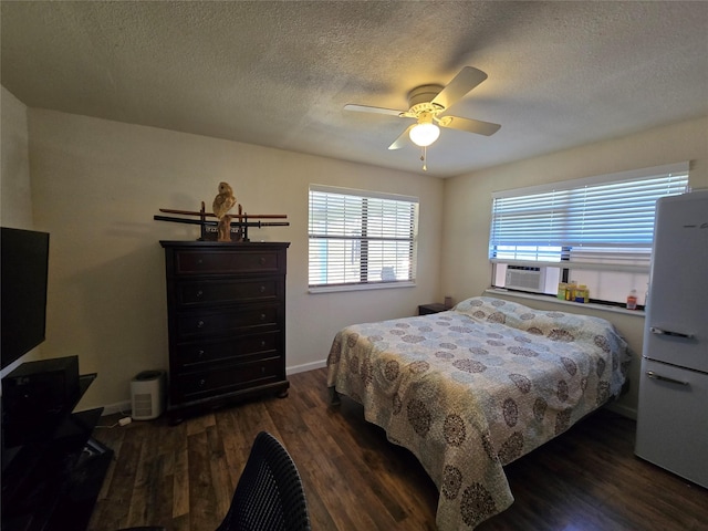 bedroom with baseboards, ceiling fan, dark wood-type flooring, a textured ceiling, and cooling unit