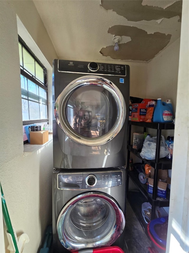 laundry area featuring stacked washer and dryer