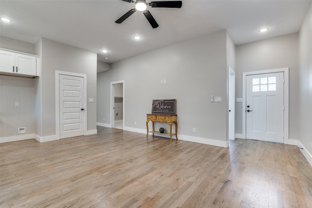 unfurnished living room with baseboards, recessed lighting, and light wood-style floors