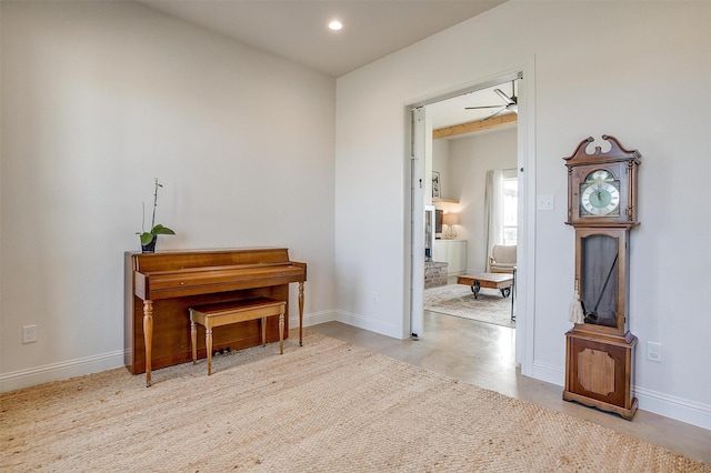 sitting room with recessed lighting, finished concrete flooring, and baseboards