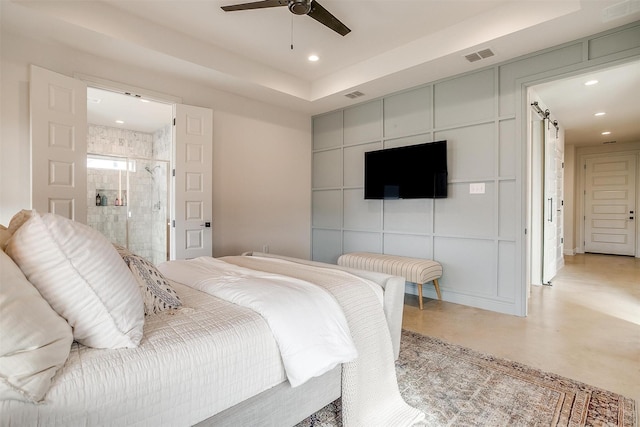 bedroom featuring concrete flooring, recessed lighting, visible vents, and a barn door