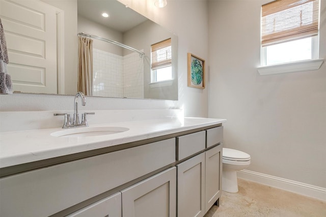 bathroom featuring baseboards, curtained shower, vanity, and a healthy amount of sunlight