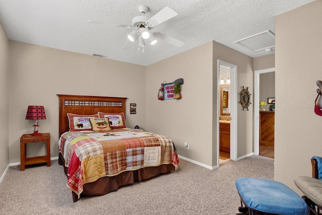 bedroom featuring light colored carpet, visible vents, attic access, a textured ceiling, and baseboards