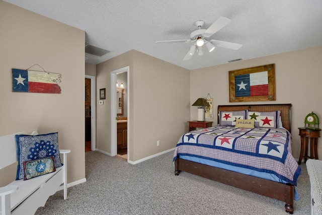 carpeted bedroom with baseboards, visible vents, ceiling fan, and a textured ceiling