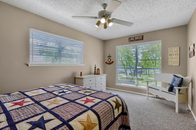 bedroom with a textured ceiling, baseboards, a ceiling fan, and light colored carpet