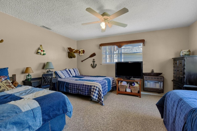 carpeted bedroom with heating unit, ceiling fan, visible vents, and a textured ceiling