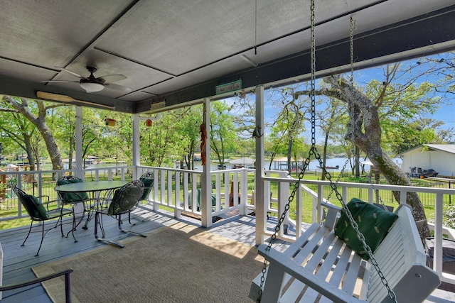 unfurnished sunroom with ceiling fan and a wealth of natural light