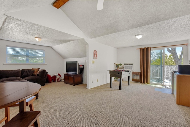 living room with lofted ceiling with beams, carpet, and a textured ceiling