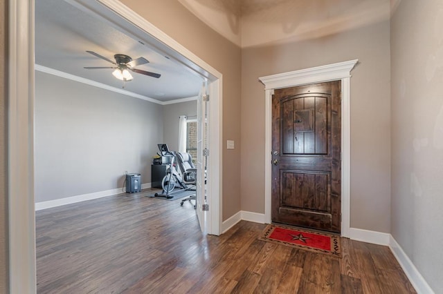 entrance foyer featuring ceiling fan, crown molding, baseboards, and wood finished floors