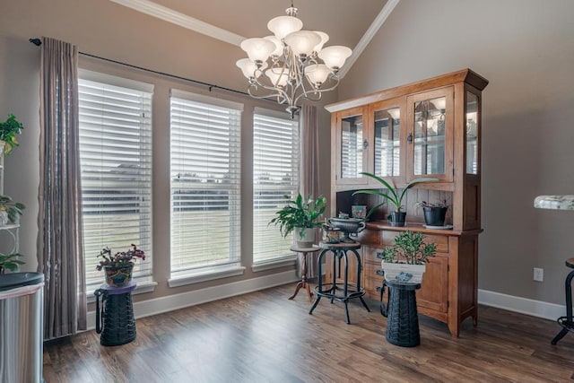 interior space featuring lofted ceiling, crown molding, and wood finished floors