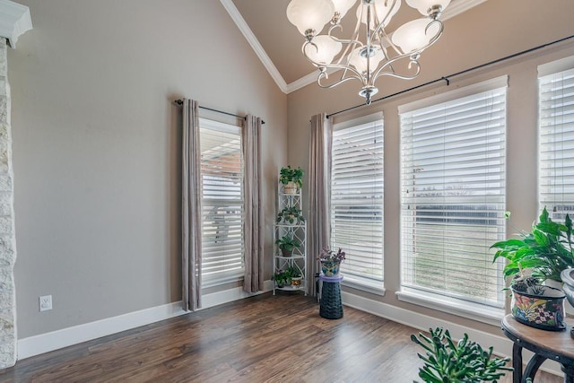 interior space featuring ornamental molding, dark wood finished floors, a wealth of natural light, and a notable chandelier