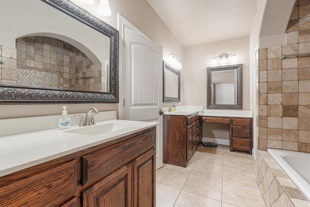 full bathroom featuring tiled bath, tile patterned flooring, two vanities, a sink, and a tile shower