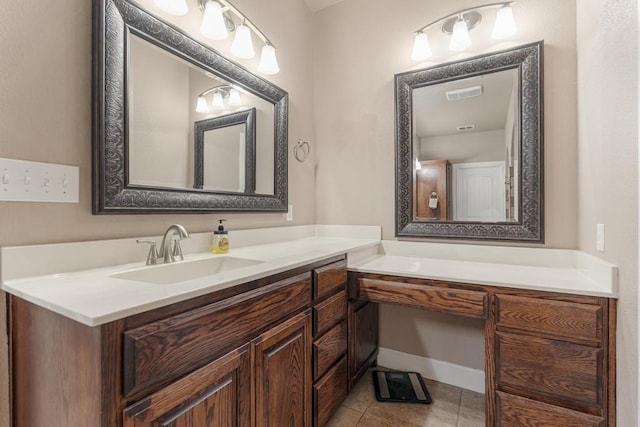 bathroom featuring visible vents, vanity, baseboards, and tile patterned floors