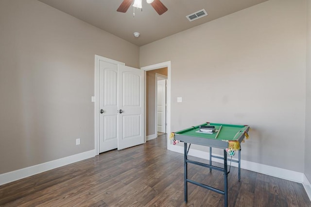 recreation room with baseboards, visible vents, and wood finished floors