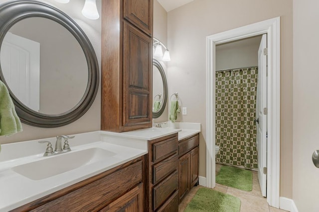 bathroom with curtained shower, tile patterned flooring, toilet, vanity, and baseboards