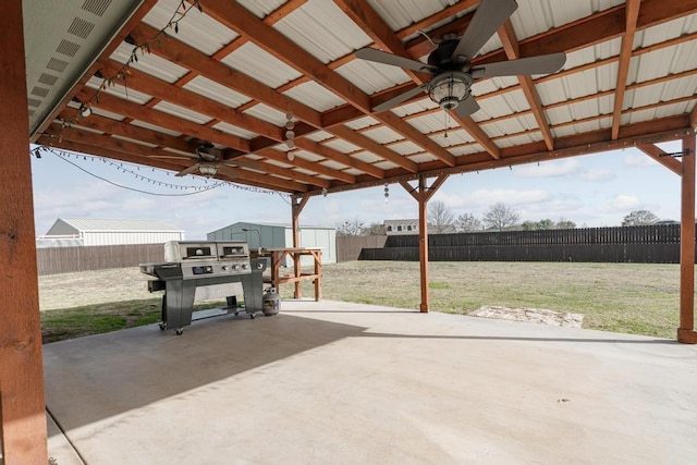 view of patio / terrace featuring a storage shed, a fenced backyard, and a ceiling fan