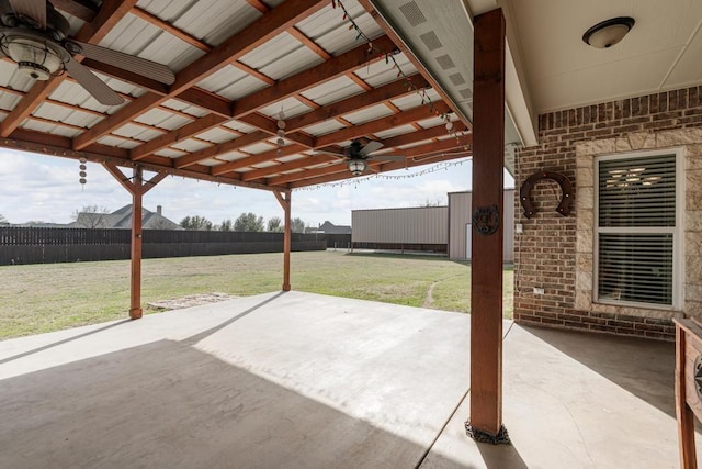 view of patio / terrace with ceiling fan and fence