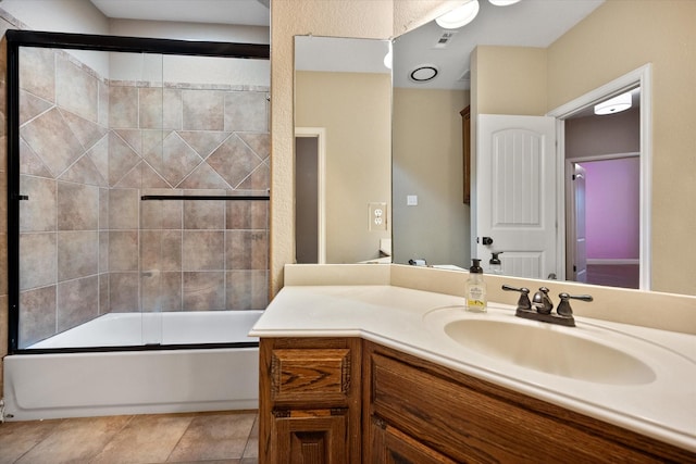 bathroom featuring visible vents, combined bath / shower with glass door, vanity, and tile patterned floors