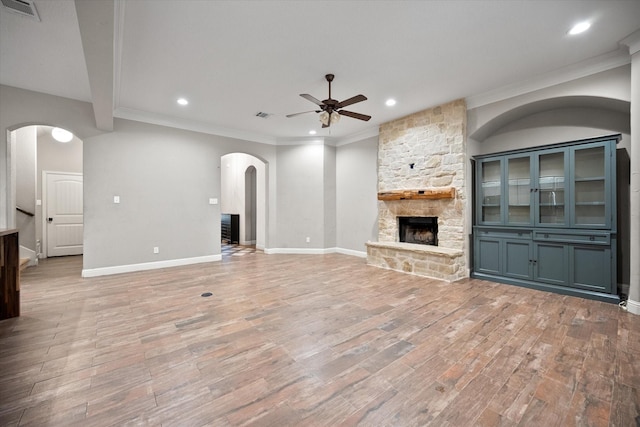 unfurnished living room featuring a ceiling fan, light wood-style flooring, visible vents, and a fireplace
