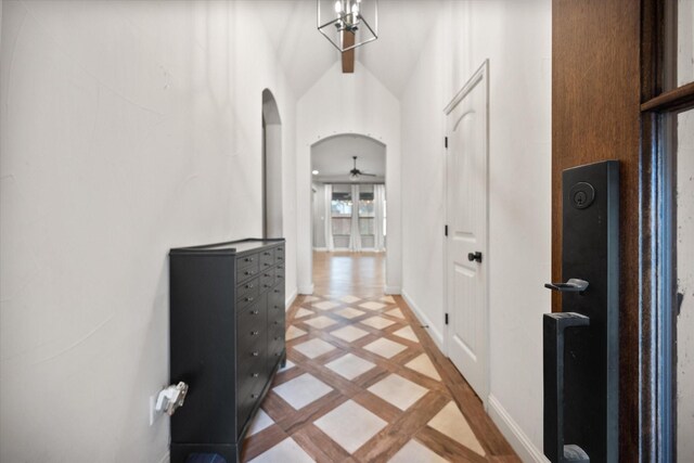 101 Chateau Dr, Aledo, TX 76008 - corridor featuring inlaid floor details, baseboards, arched walkways, and vaulted ceiling