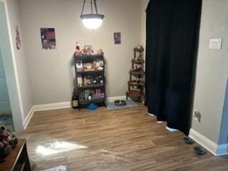 dining area featuring wood finished floors and baseboards