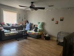 bedroom with a ceiling fan and wood finished floors