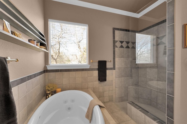 bathroom featuring a tub with jets, ornamental molding, and tile walls