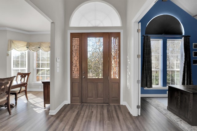 entrance foyer with ornamental molding, dark wood-type flooring, and baseboards