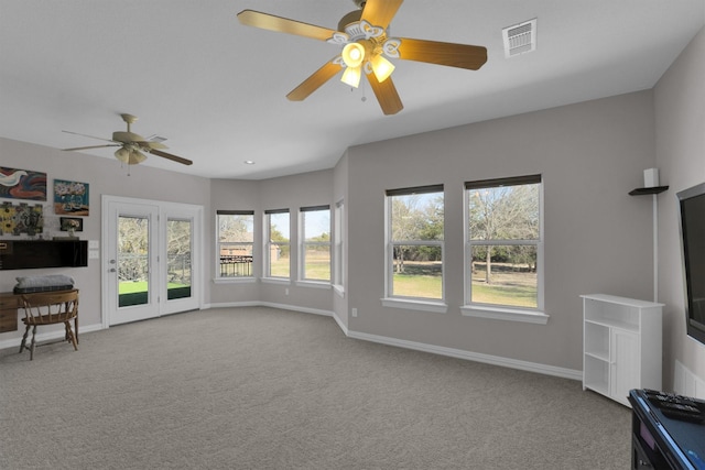 living area featuring light carpet, a ceiling fan, visible vents, and baseboards