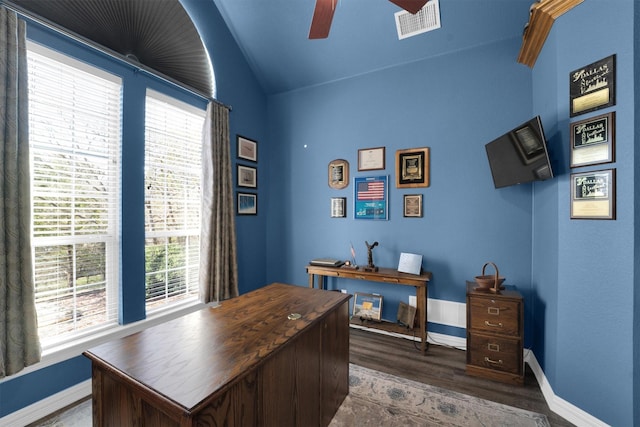 office space with baseboards, visible vents, a ceiling fan, lofted ceiling, and dark wood-style floors