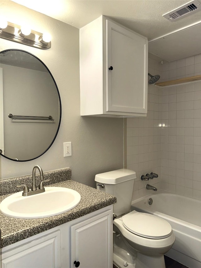 bathroom featuring bathtub / shower combination, visible vents, toilet, vanity, and a textured ceiling