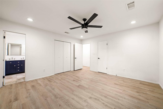 2209 9th St, Brownwood, TX 76801 - unfurnished bedroom featuring light wood-style flooring, recessed lighting, baseboards, ensuite bath, and a ceiling fan
