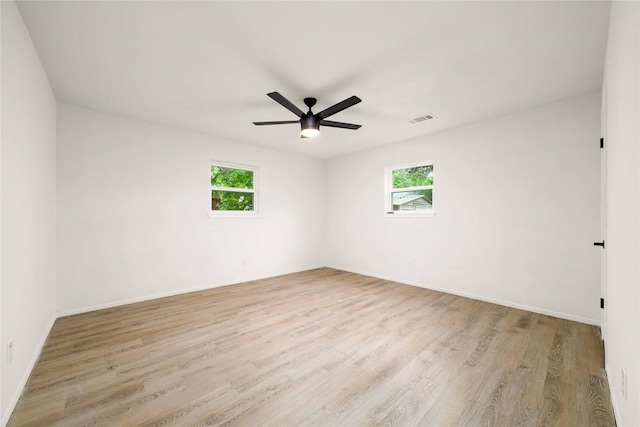 2209 9th St, Brownwood, TX 76801 - unfurnished room featuring healthy amount of natural light, wood finished floors, ceiling fan, and baseboards