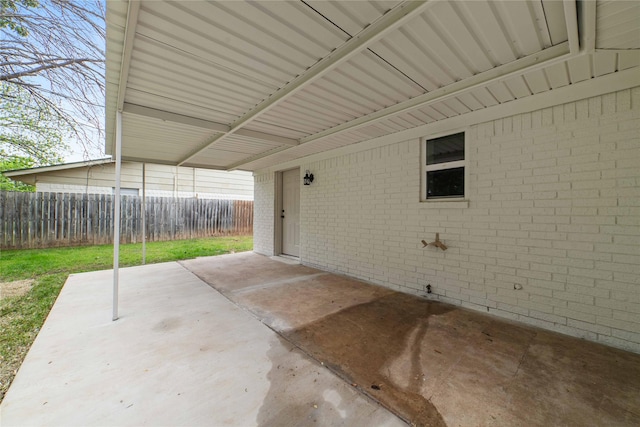2209 9th St, Brownwood, TX 76801 - view of patio / terrace with fence and an attached carport