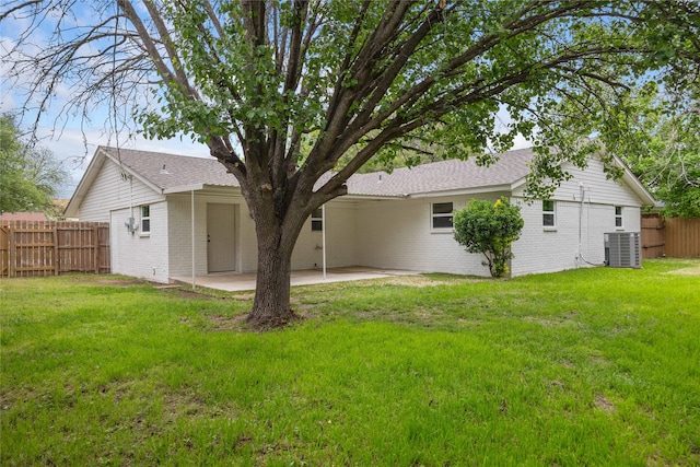2209 9th St, Brownwood, TX 76801 - back of property featuring central AC unit, a patio area, and brick siding