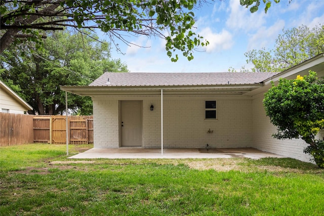 2209 9th St, Brownwood, TX 76801 - back of house featuring a patio area and brick siding