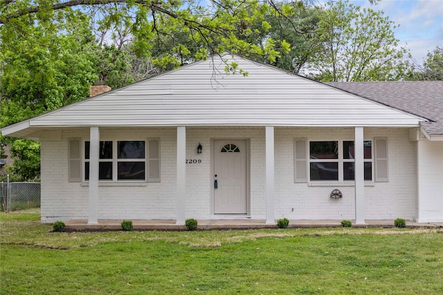 2209 9th St, Brownwood, TX 76801 - bungalow featuring brick siding, roof with shingles, a chimney, and a porch
