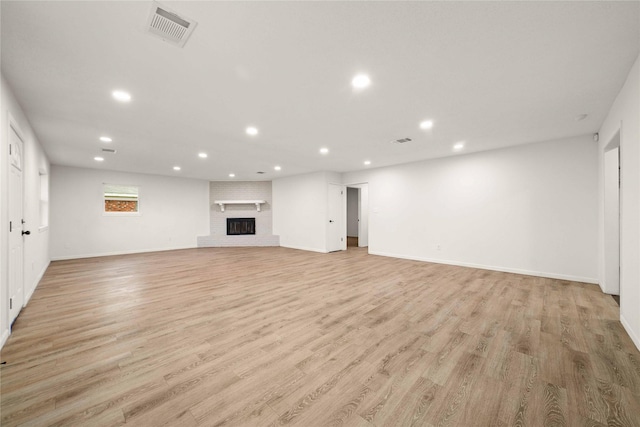2209 9th St, Brownwood, TX 76801 - below grade area with recessed lighting, baseboards, light wood finished floors, and a brick fireplace