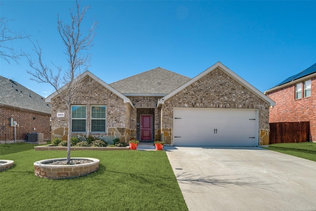 ranch-style home featuring a shingled roof, concrete driveway, an attached garage, a front yard, and brick siding