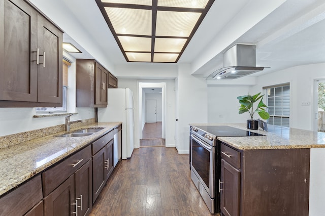 kitchen with dark wood finished floors, island exhaust hood, stainless steel appliances, a sink, and light stone countertops